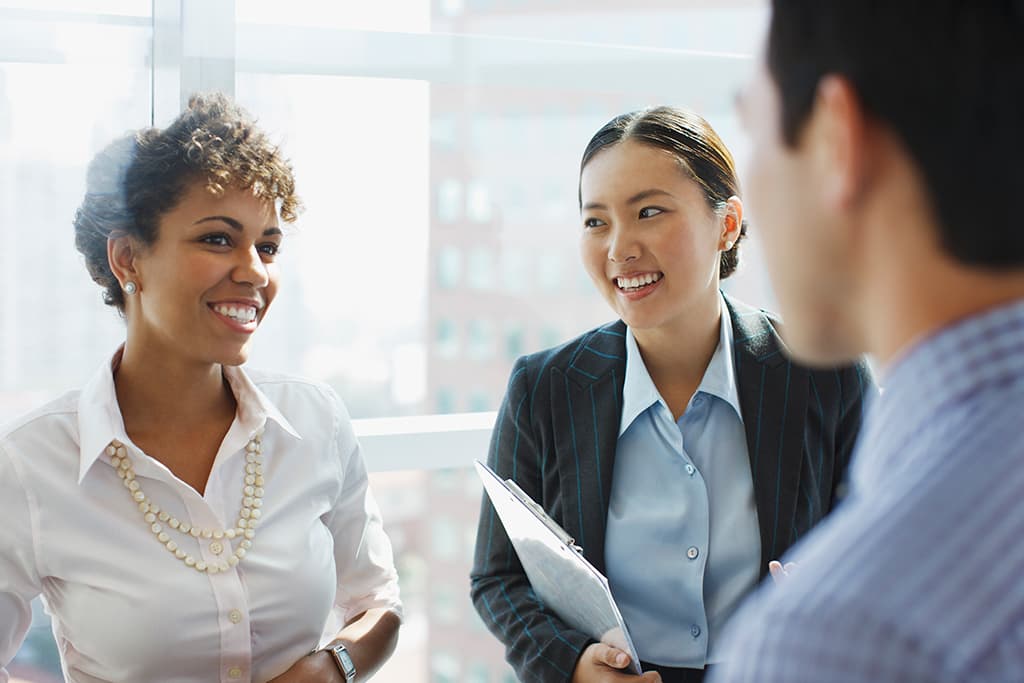 Three business people talking in office